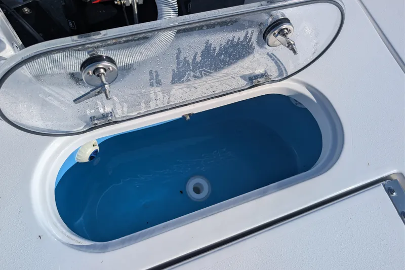 Slide: The Image of Livewell compartment on 2026 Tidewater 2500 Carolina Bay boat, featuring a clear lid. - 13