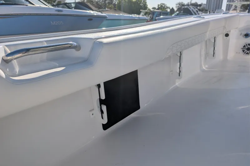 Slide: The Image of 2026 Tidewater 2500 Carolina Bay boat interior with sleek white finish and stainless steel handle. - 18