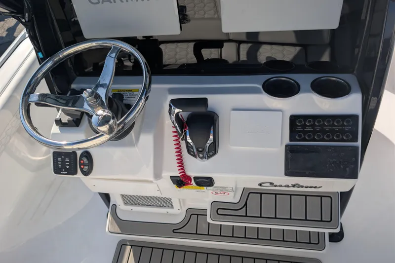 Slide: The Image of 2026 Tidewater 2500 Carolina Bay boat dashboard with steering wheel and controls. - 19