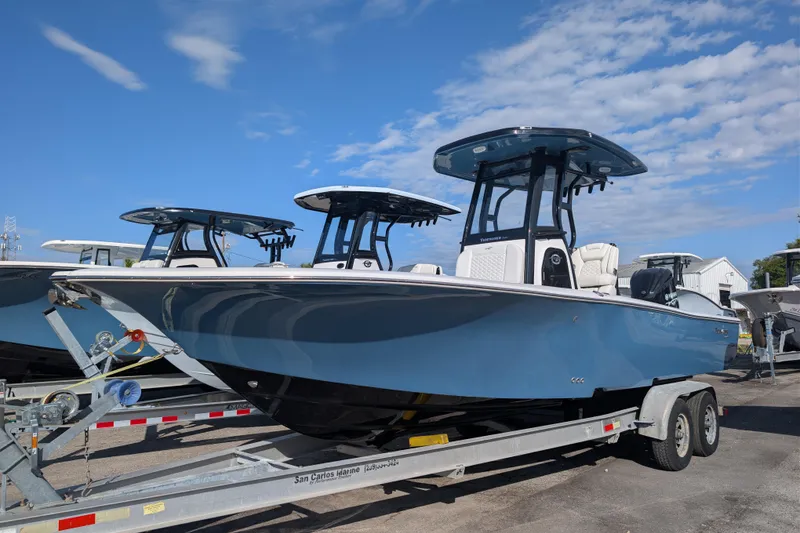 Slide: The Image of 2026 Tidewater 2500 Carolina Bay boat on trailer under blue sky. - 21