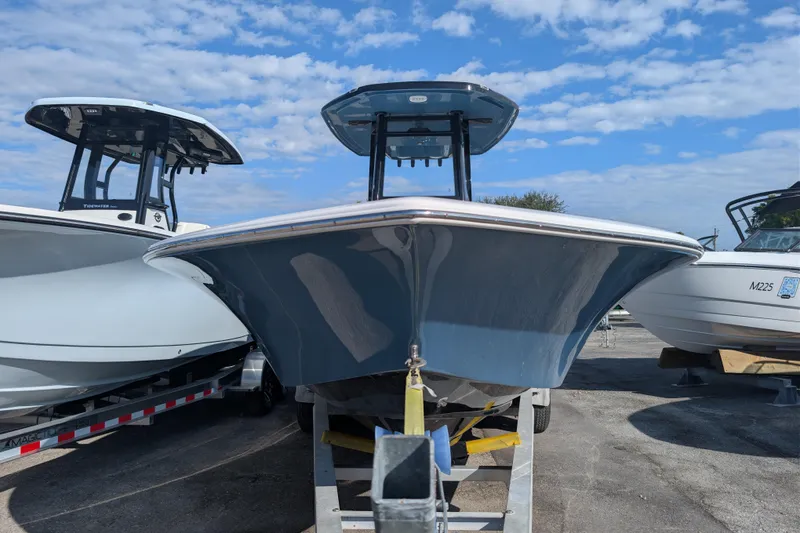 Slide: The Image of 2026 Tidewater 2500 Carolina Bay boat on trailer under blue sky. - 22