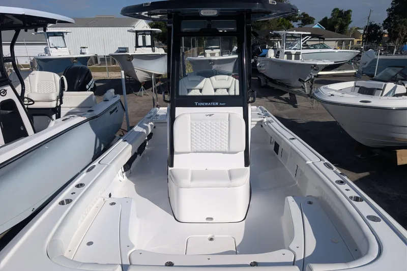 Slide: The Image of 2026 Tidewater 2500 Carolina Bay boat, sleek design, spacious deck, marina setting. - 25