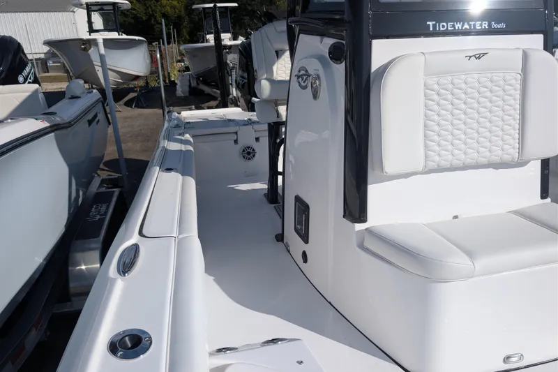 Slide: The Image of 2026 Tidewater 2500 Carolina Bay boat interior with white seating and sleek design. - 26