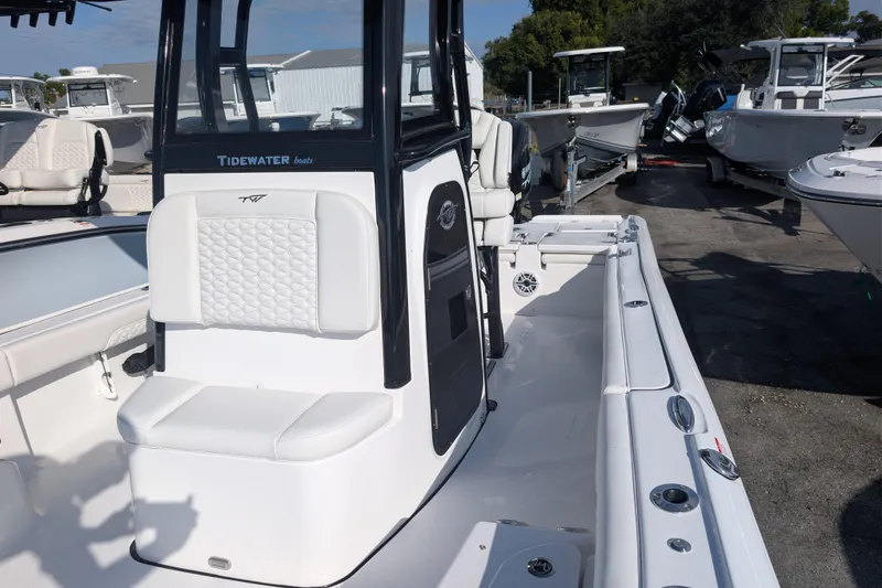 Slide: The Image of 2026 Tidewater 2500 Carolina Bay boat interior with white seating and sleek design. - 27