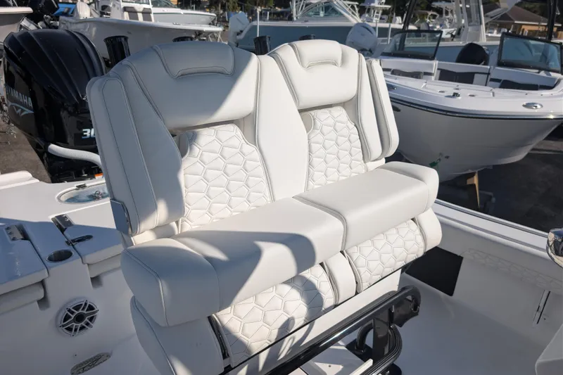 Slide: The Image of 2026 Tidewater 2500 Carolina Bay boat with luxurious white seating and Yamaha engine. - 3