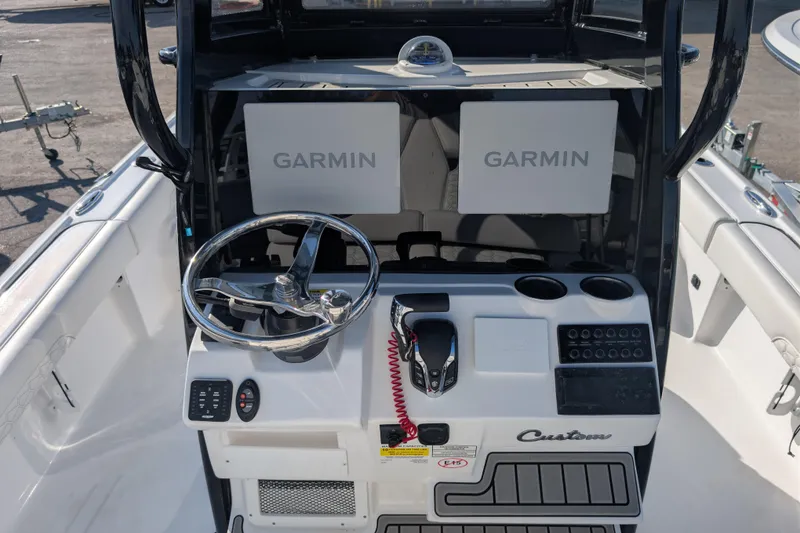 Slide: The Image of 2026 Tidewater 2500 Carolina Bay boat console with Garmin displays and steering wheel. - 5