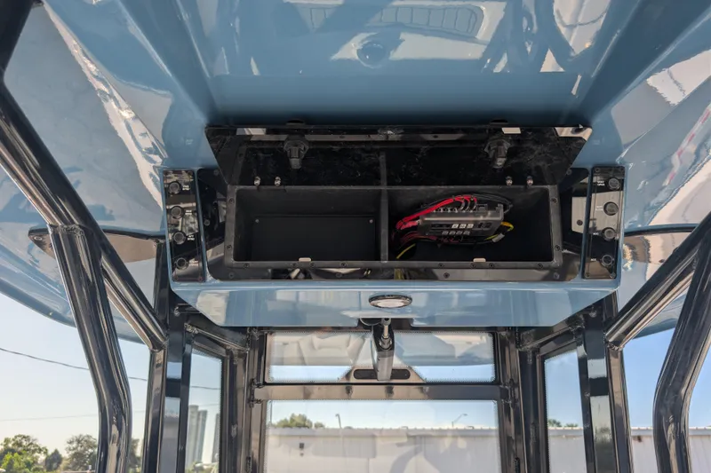 Slide: The Image of 2026 Tidewater 2500 Carolina Bay boat console with open electrical panel. - 8