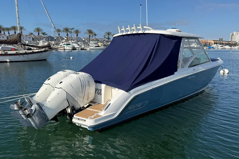 Slide: The Image of 2020 Boston Whaler 320 Vantage boat docked in marina with twin Mercury engines. - 13