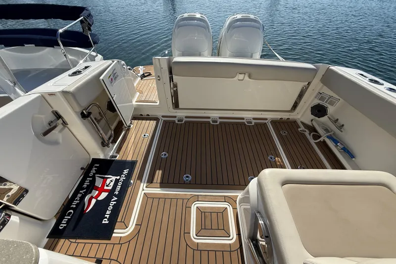 Slide: The Image of 2020 Boston Whaler 320 Vantage boat interior with teak flooring and seating. - 17