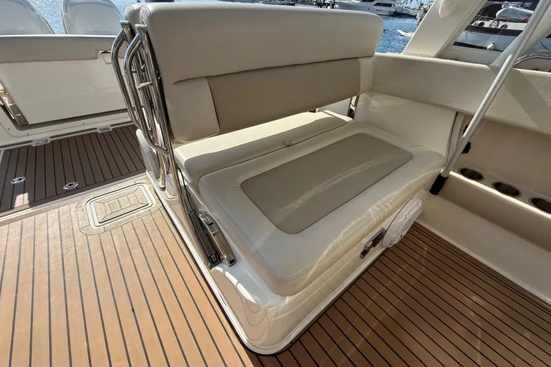 Slide: The Image of 2020 Boston Whaler 320 Vantage boat interior with seating, docked in a marina. - 22