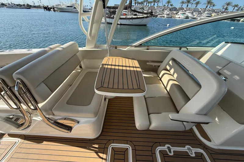 Slide: The Image of 2020 Boston Whaler 320 Vantage interior with elegant seating and wooden flooring. - 27