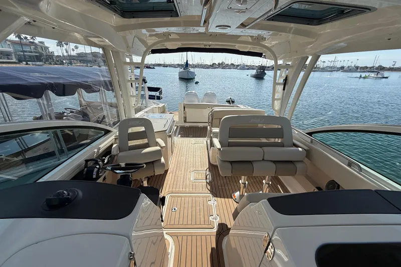 Slide: The Image of 2020 Boston Whaler 320 Vantage boat interior with luxurious seating and wooden deck. - 32