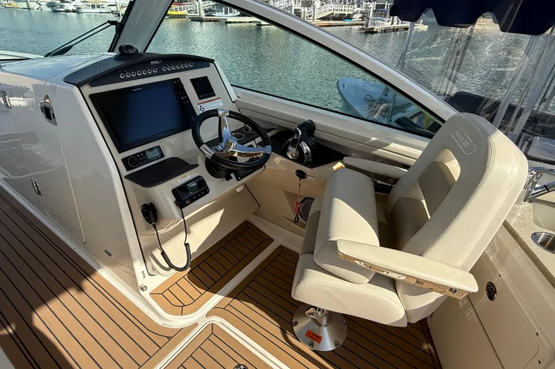 Slide: The Image of Captain's chair on 2020 Boston Whaler 320 Vantage boat, featuring luxurious seating and controls. - 35