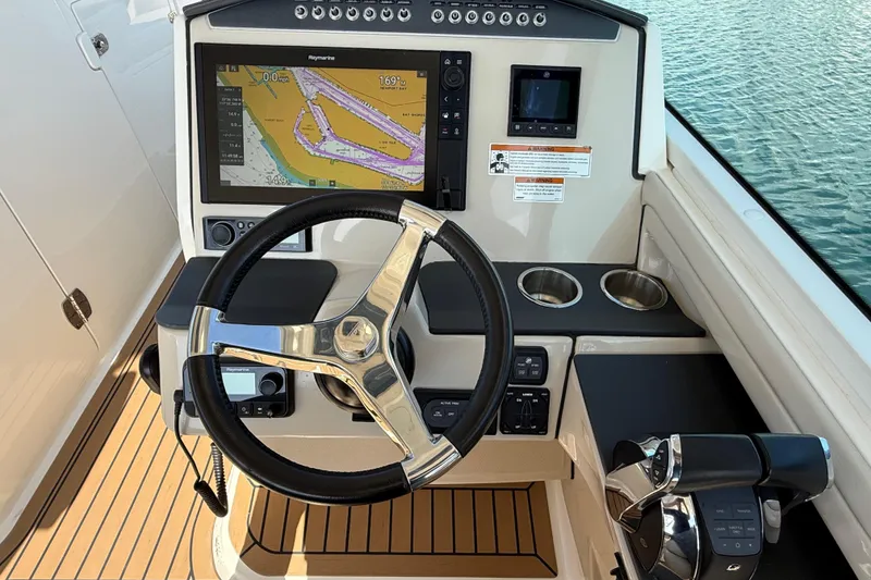 Slide: The Image of 2020 Boston Whaler 320 Vantage helm with navigation display and steering wheel. - 37