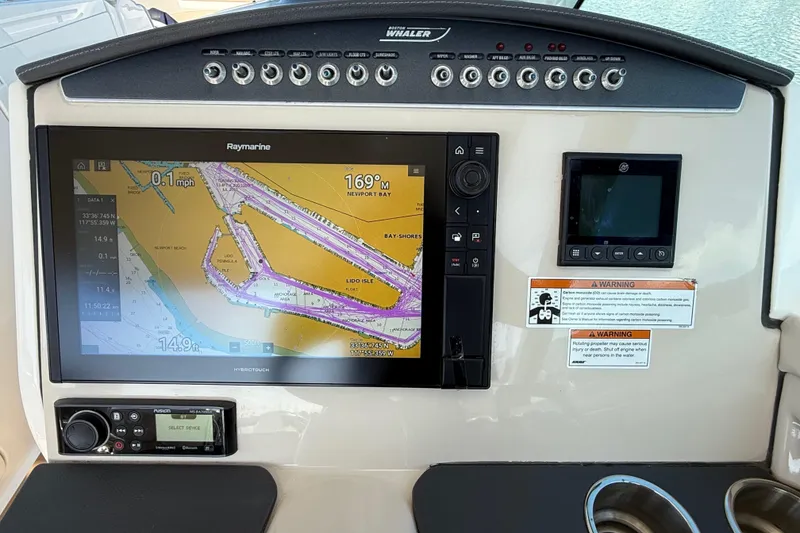 Slide: The Image of Helm of 2020 Boston Whaler 320 Vantage with navigation display and controls. - 38