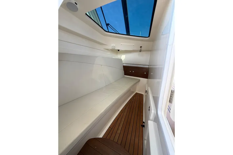 Slide: The Image of Interior cabin of 2020 Boston Whaler 320 Vantage with skylight and wooden flooring. - 45