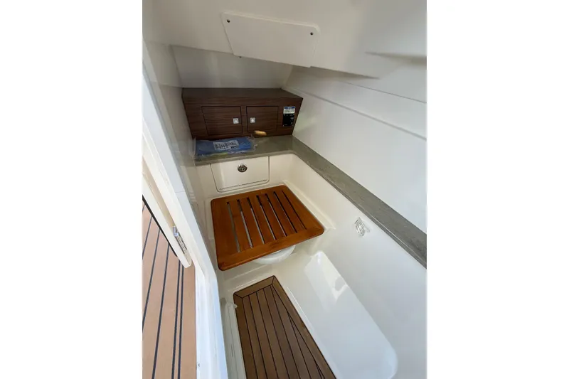 Slide: The Image of 2020 Boston Whaler 320 Vantage interior with wooden accents and storage compartments. - 47