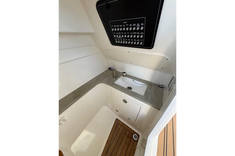 Slide: The Image of 2020 Boston Whaler 320 Vantage interior with sink and control panel. - 48