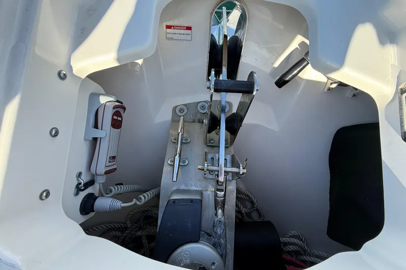 Slide: The Image of Anchor compartment of 2020 Boston Whaler 320 Vantage boat, featuring winch and ropes. - 53