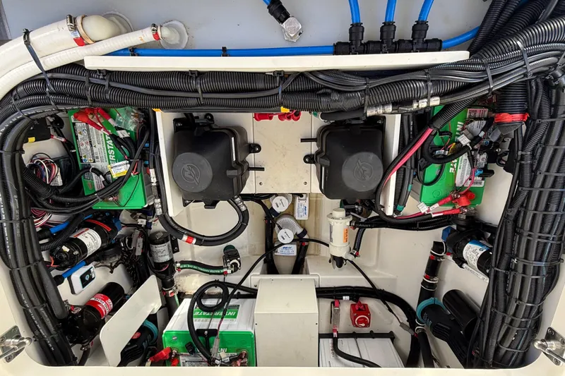 Slide: The Image of Engine compartment of a 2020 Boston Whaler 320 Vantage, showcasing wiring and components. - 54