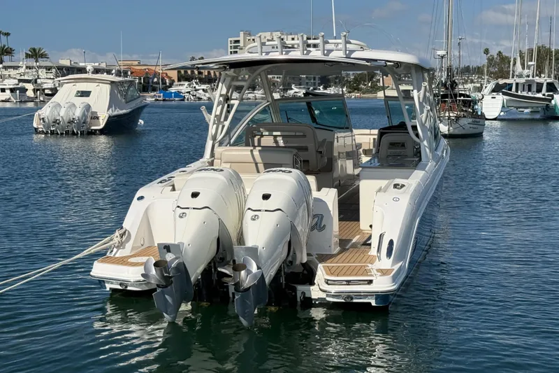 Slide: The Image of 2020 Boston Whaler 320 Vantage boat docked in marina with twin engines. - 7