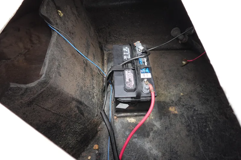 Slide: The Image of Battery compartment of 2022 Stingray 231 DC boat with visible wiring. - 18