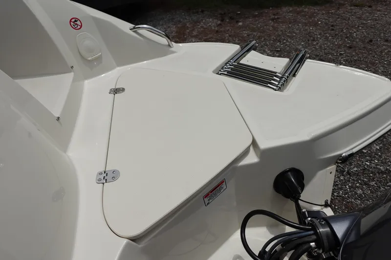 Slide: The Image of 2022 Stingray 231 DC boat stern with swim platform and ladder. - 20