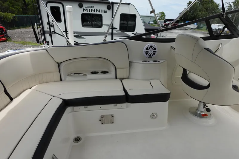Slide: The Image of 2022 Stingray 231 DC boat interior with seating and cup holders. - 25