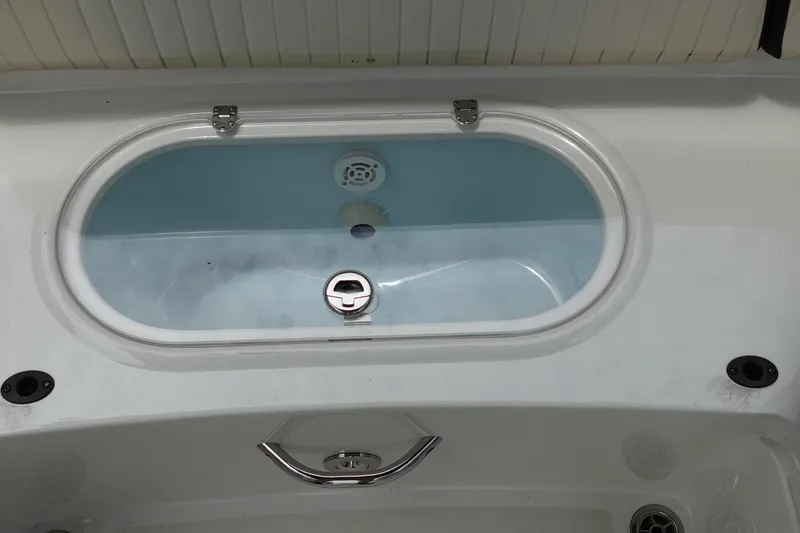 Slide: The Image of 2022 Stingray 231 DC boat livewell with clear lid and latch. - 29