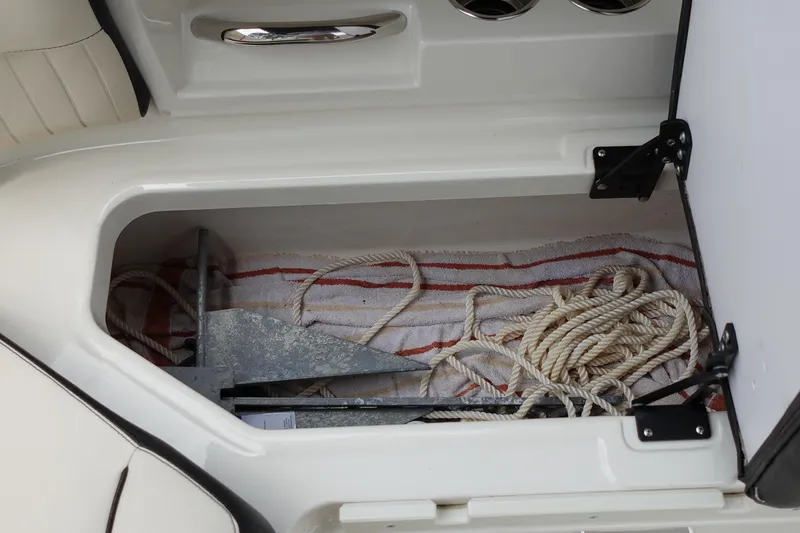 Slide: The Image of Storage compartment in 2022 Stingray 231 DC boat with anchor and rope. - 32
