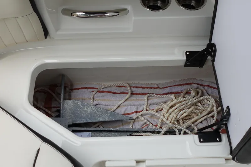 Slide: The Image of Storage compartment in a 2022 Stingray 231 DC boat with anchor and rope. - 33
