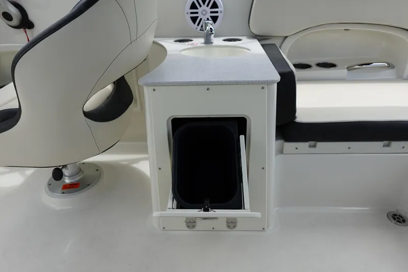 Slide: The Image of 2022 Stingray 231 DC boat interior with seating, storage, and speaker. - 36