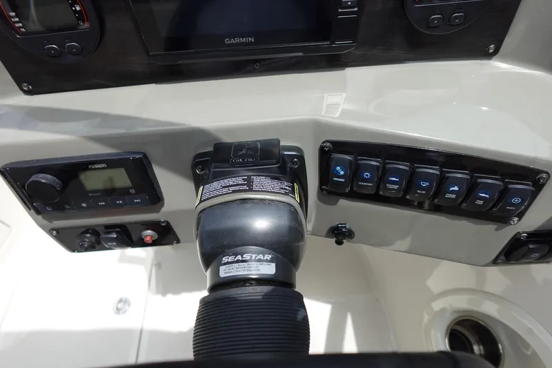 Slide: The Image of Control panel of 2022 Stingray 231 DC boat with SeaStar steering and Garmin display. - 46