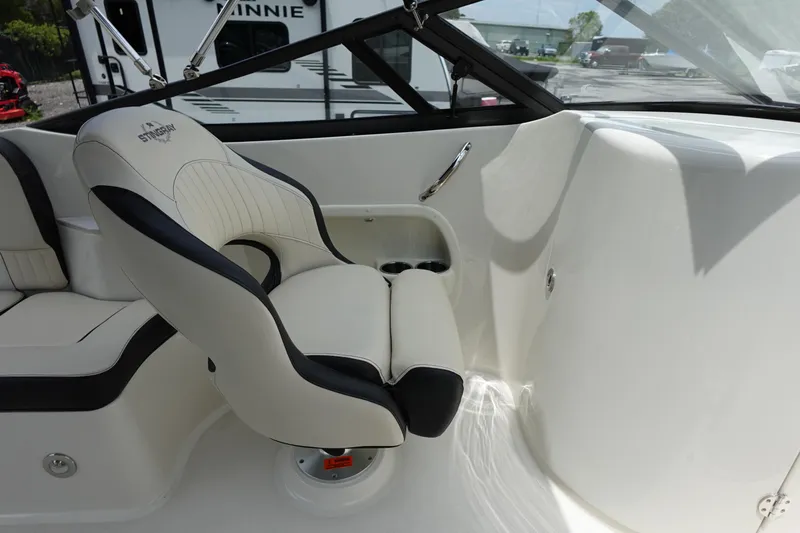 Slide: The Image of 2022 Stingray 231 DC boat interior with plush seating and sleek design. - 47