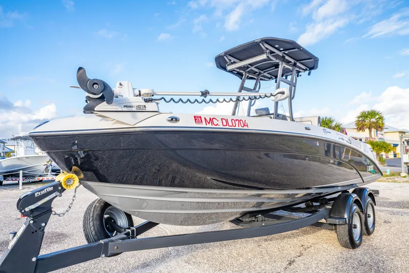 Slide: The Image of 2019 Yamaha Boats 210 FSH Sport on trailer, clear sky background. - 10
