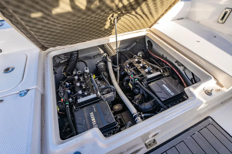 Slide: The Image of 2019 Yamaha Boats 210 FSH Sport engine compartment, showcasing dual Yamaha engines. - 12