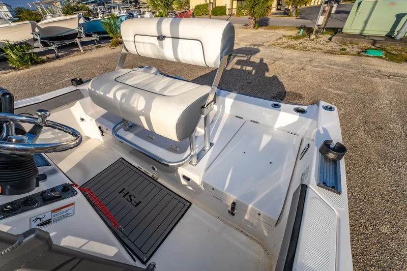 Slide: The Image of 2019 Yamaha Boats 210 FSH Sport interior with steering wheel and seating area. - 15