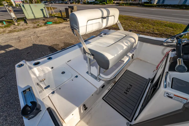 Slide: The Image of 2019 Yamaha Boats 210 FSH Sport interior with seating and deck features. - 16