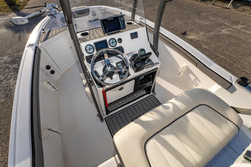 Slide: The Image of 2019 Yamaha Boats 210 FSH Sport interior with steering wheel and control panel. - 19