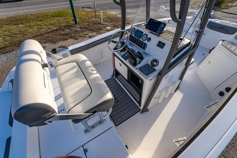 Slide: The Image of 2019 Yamaha Boats 210 FSH Sport interior with helm, seating, and controls. - 20