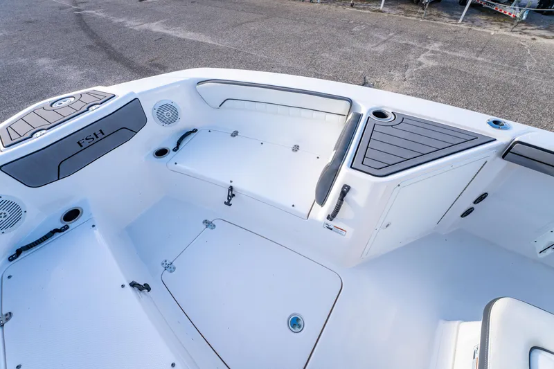 Slide: The Image of 2019 Yamaha Boats 210 FSH Sport interior, featuring seating and storage compartments. - 28