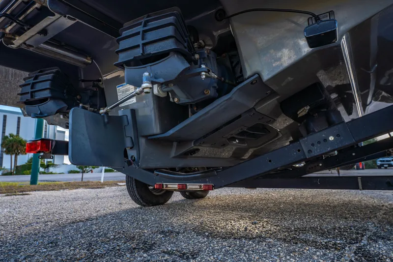 Slide: The Image of 2019 Yamaha Boats 210 FSH Sport interior with steering wheel, docked in a marina. - 36