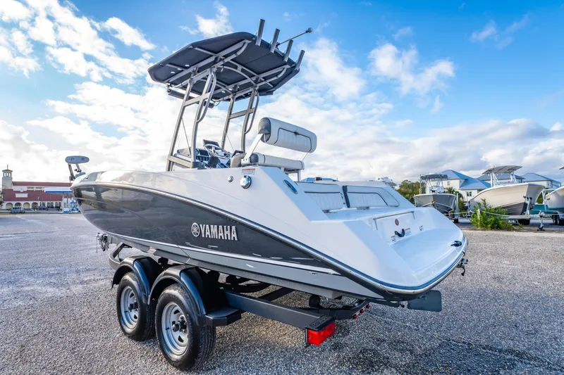 Slide: The Image of 2019 Yamaha Boats 210 FSH Sport on trailer, parked outdoors under blue sky. - 8