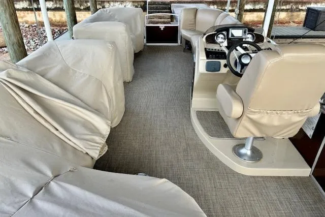 Slide: The Image of 2019 Godfrey Sweetwater pontoon boat interior with covered seating and helm. - 4