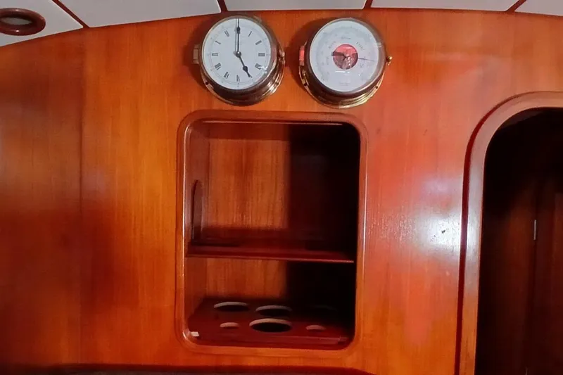 Slide: The Image of Wooden interior of 1994 Beneteau Oceanis 44 CC with clock and barometer. - 16