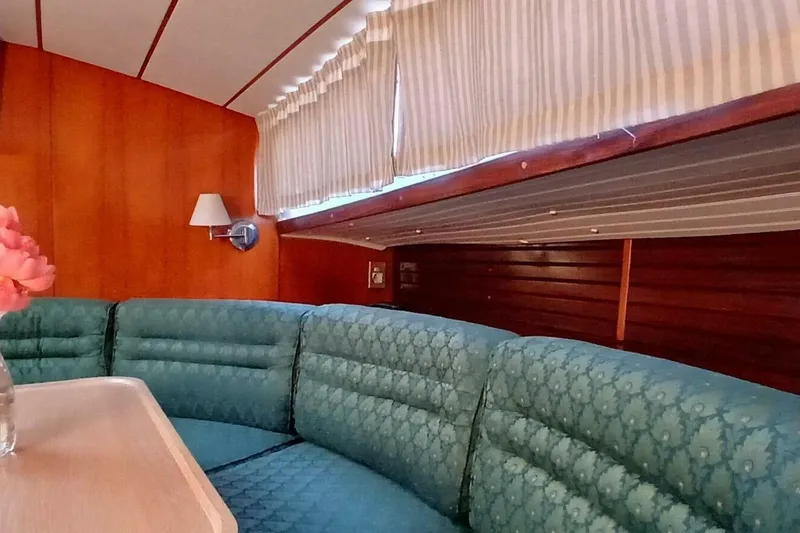 Slide: The Image of Interior of 1994 Beneteau Oceanis 44 CC yacht with cozy seating and wood paneling. - 20