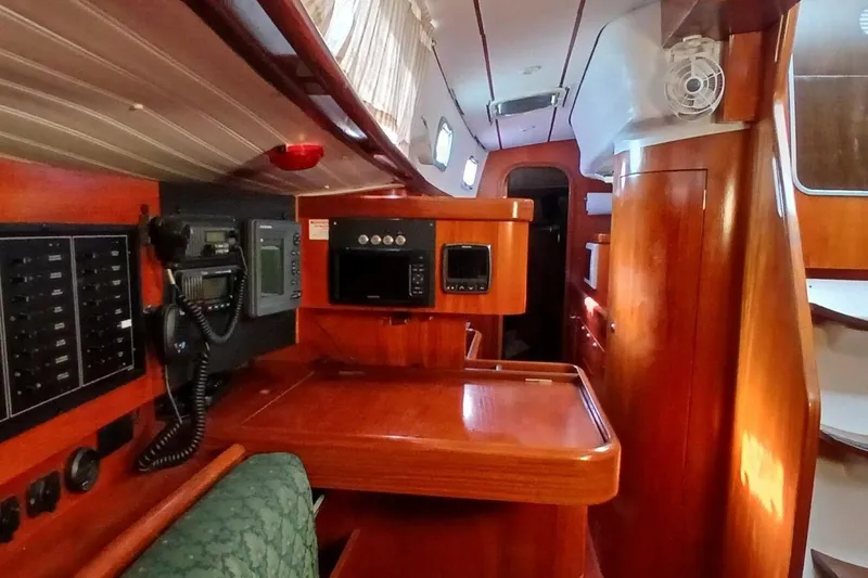 Slide: The Image of Interior of 1994 Beneteau Oceanis 44 CC sailboat with wooden cabinetry and navigation equipment. - 22