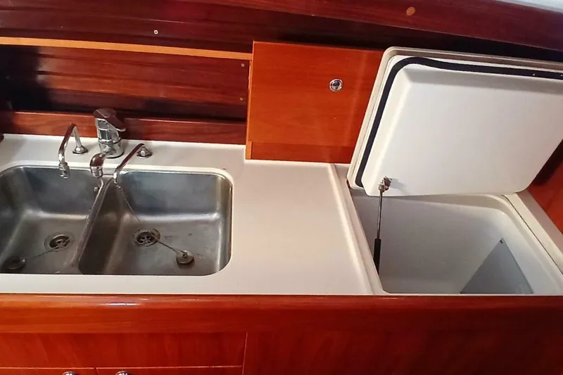 Slide: The Image of Galley sink and storage in 1994 Beneteau Oceanis 44 CC yacht kitchen. - 28