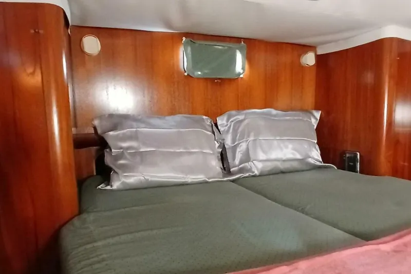 Slide: The Image of Cozy cabin interior of 1994 Beneteau Oceanis 44 CC with wooden paneling and comfortable bedding. - 39