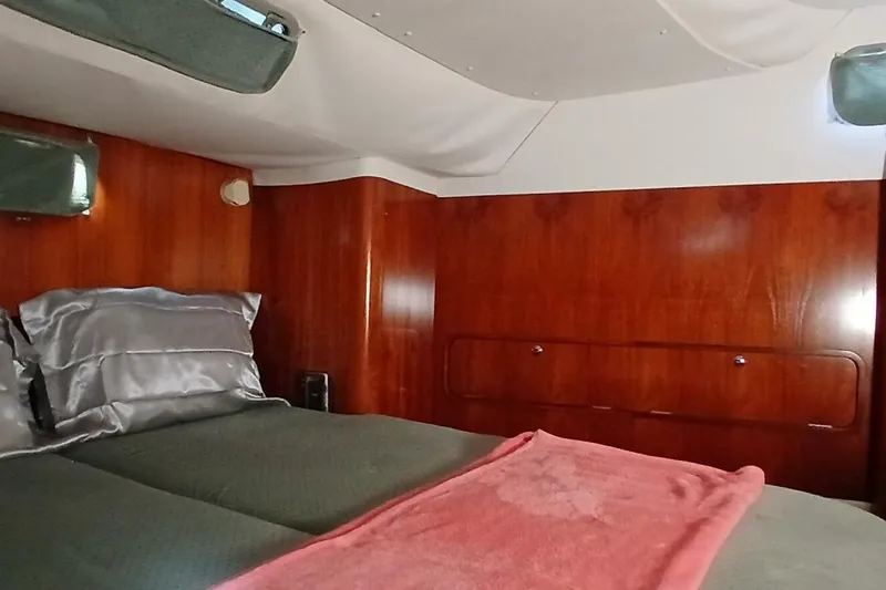 Slide: The Image of Cozy cabin interior of 1994 Beneteau Oceanis 44 CC sailboat with wood paneling and bedding. - 41